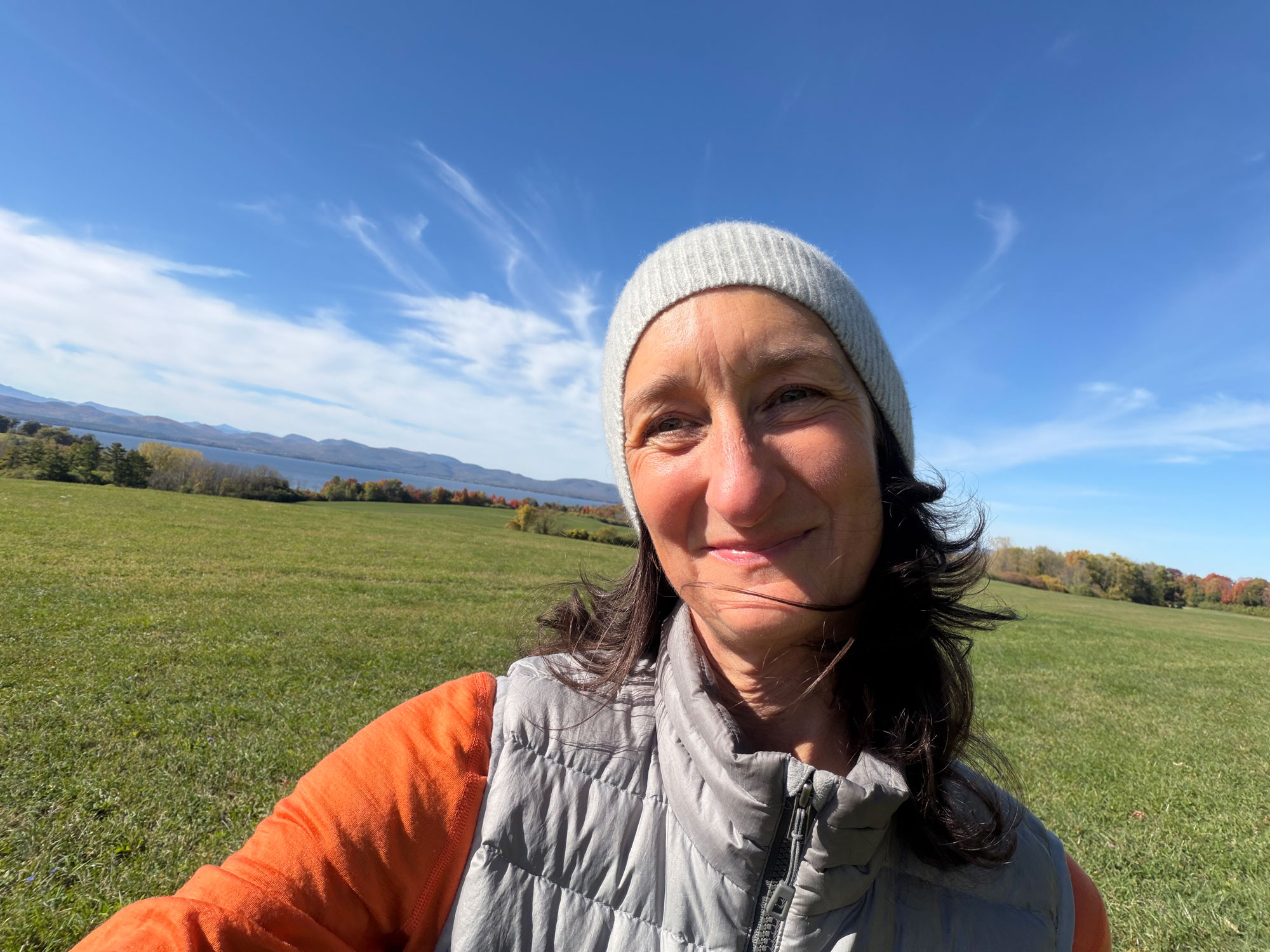 Paige Kelly wearing knit cap smiling in field